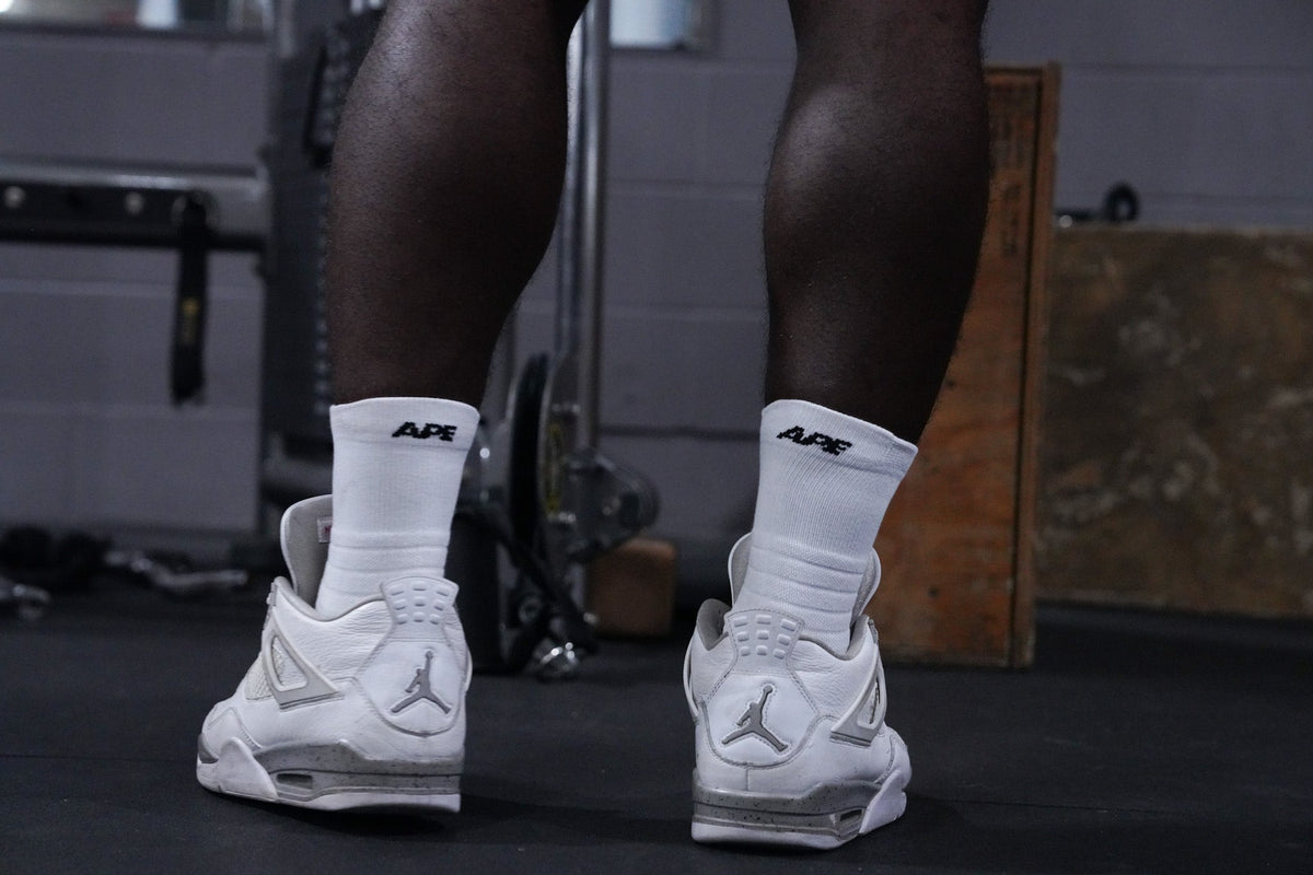 APE socks with white sneakers in the gym