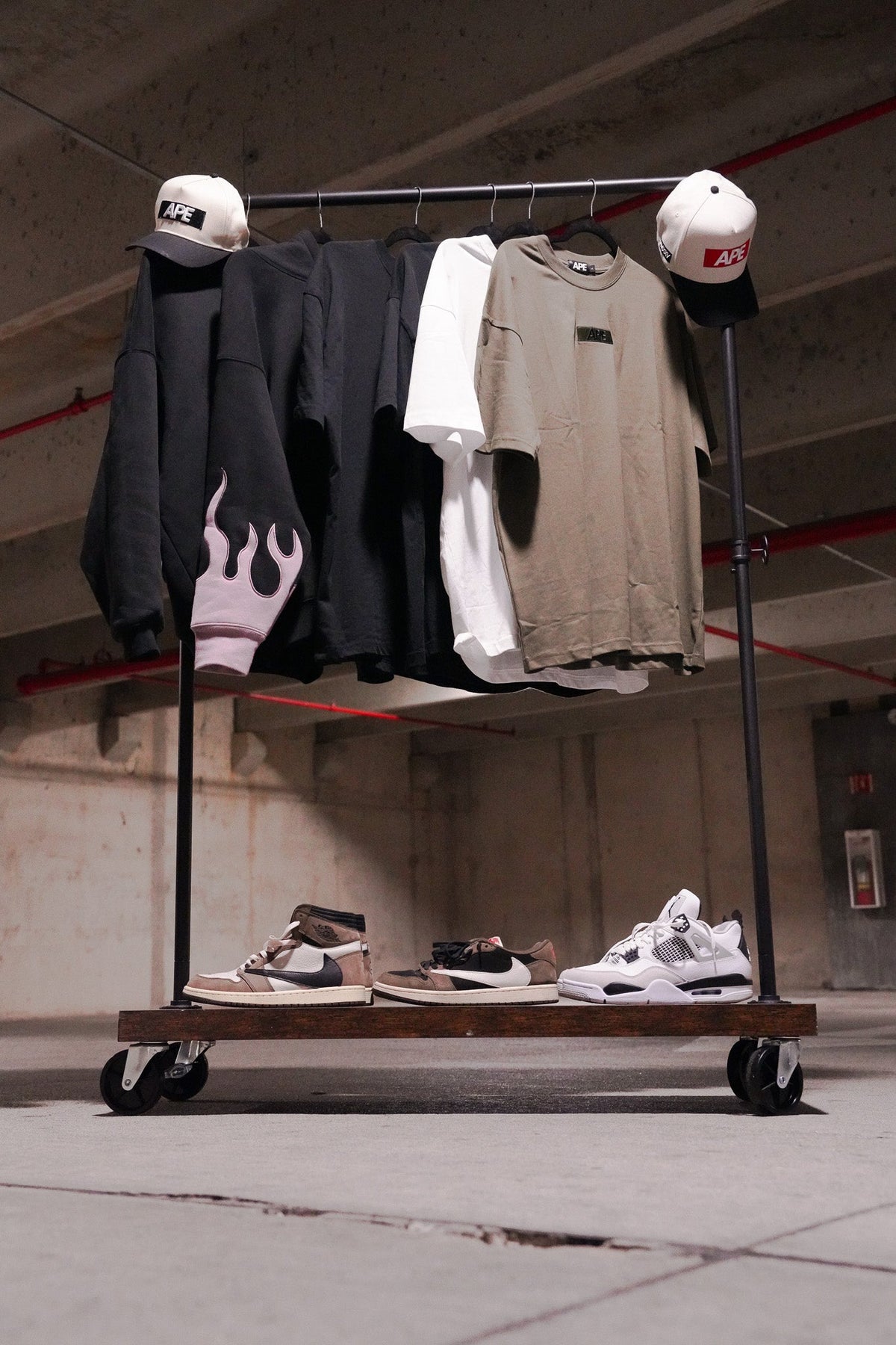 APE tees and hoodies on a clothing rack