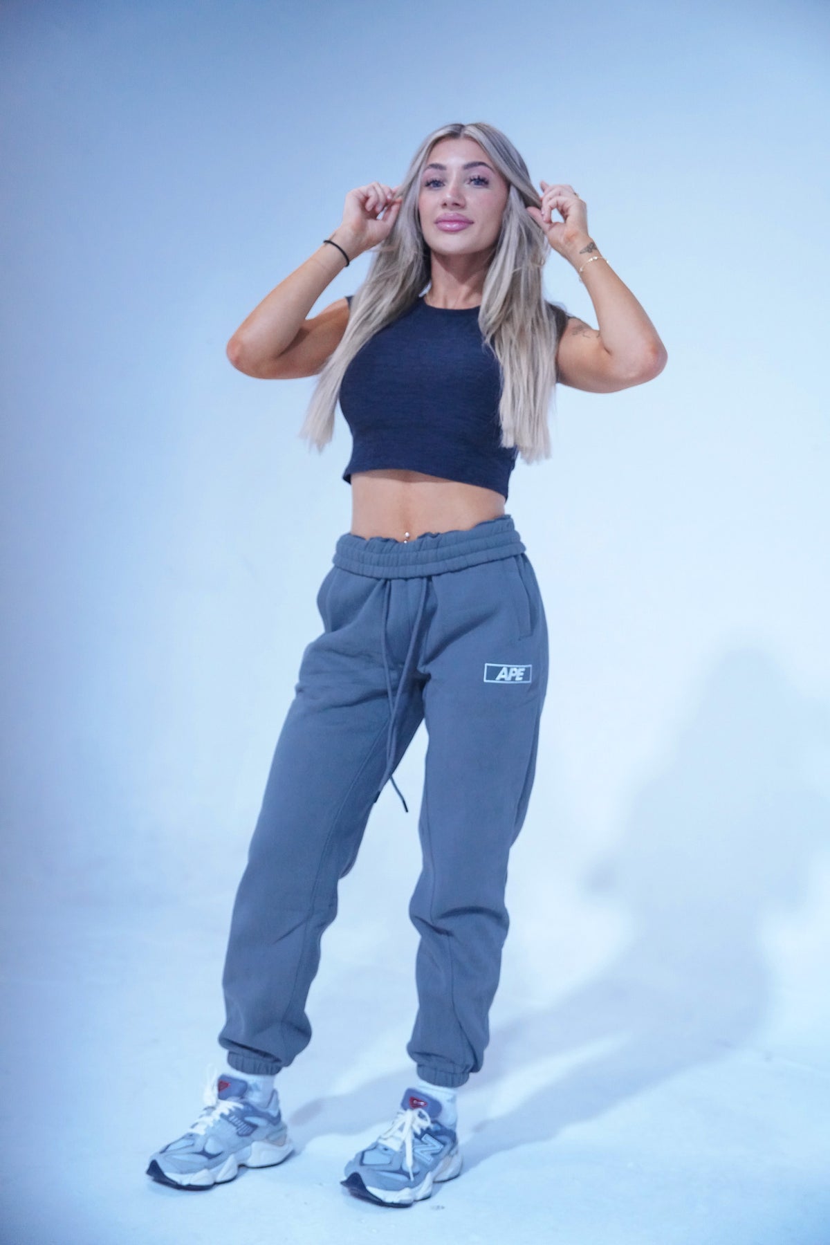 Sweats in gray, worn with a cropped top